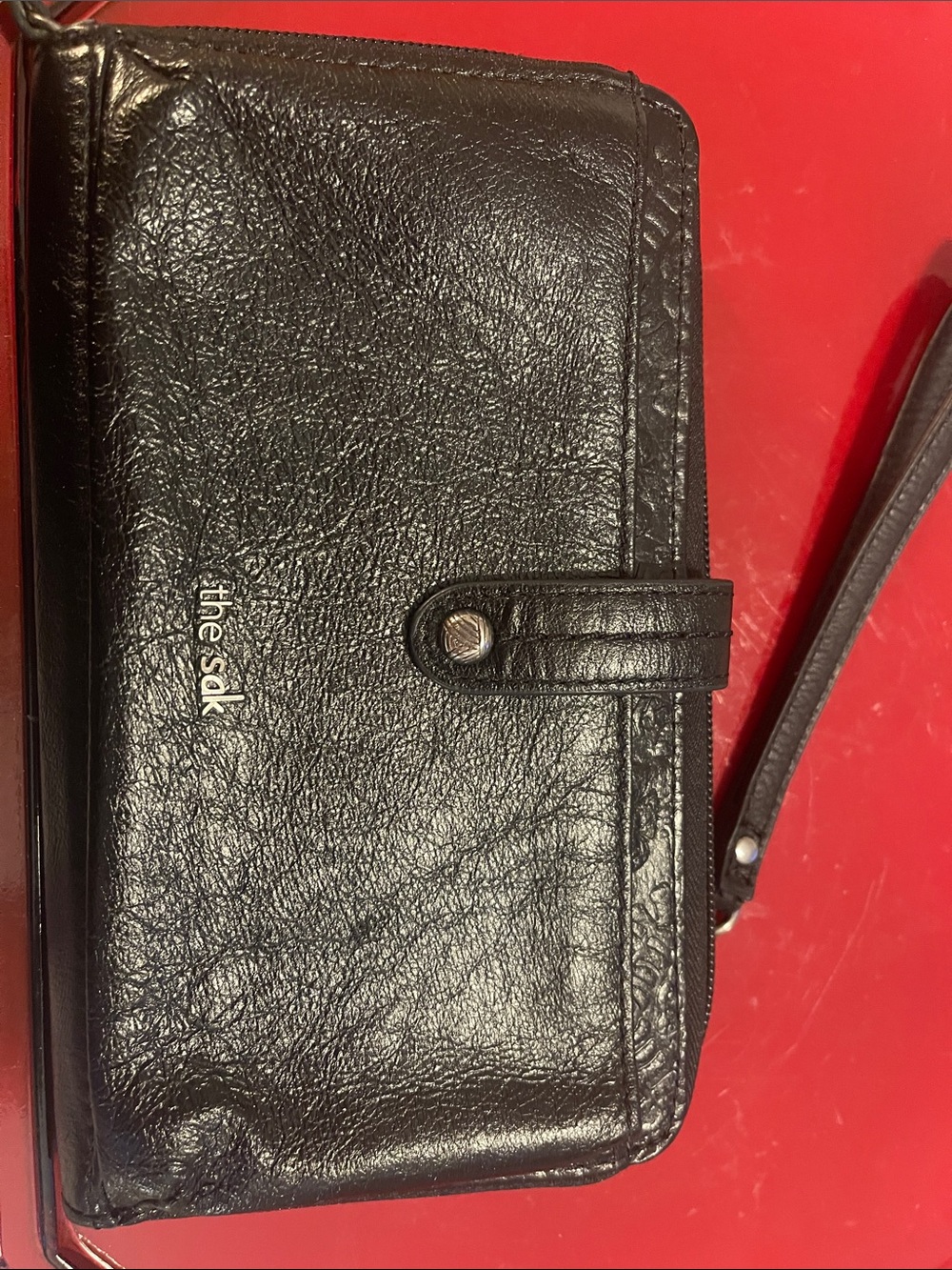 The Sak Black Leather Wristlet Clutch with Snap Strap